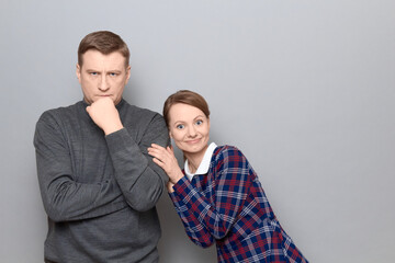 Studio portrait of couple, woman is hugging man, relationship concept