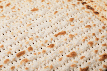Traditional matzo as background, closeup. Pesach celebration