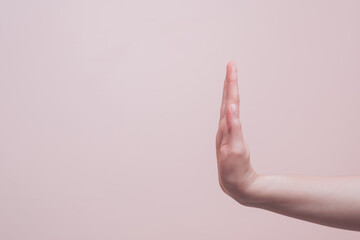 Female hand showing stop and no sign gesture, copy space