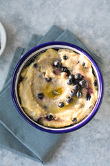 Polenta traditional corn food in the plate with blueberry.
