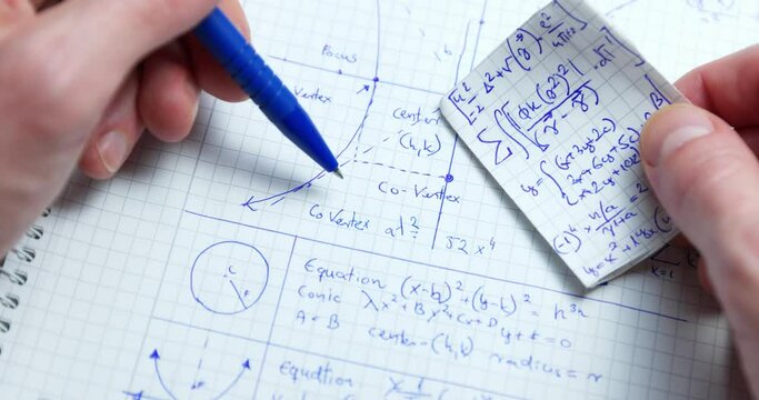 Man writing math exercise in notebook closeup