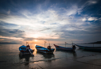 boats on the seashore at sunset