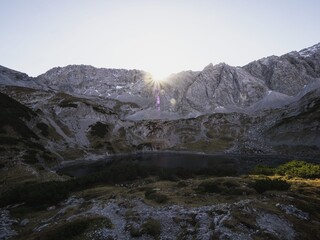 Alpine autumn fall sunset panorama of Drachensee lake rocky mountain massif in Ehrwald Tyrol...