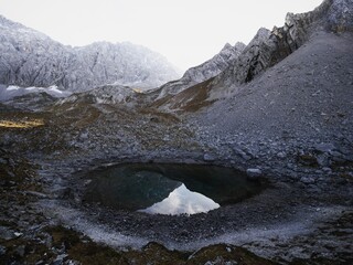 Alpine autumn fall sunset panorama of Brendlsee lake rocky mountain massif in Ehrwald Tyrol Austria...