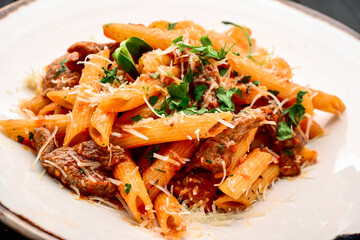 Pasta with veal, tomato sauce and cheese