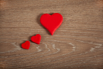 Red hearts on the wooden texture desk