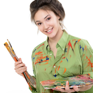 Attractive Girl Painting With Oil Paints, Professional Painter At Work Over White Background. Studio Portrait Of Young Woman Artist