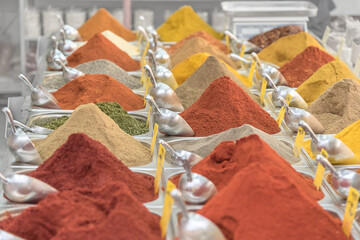 Mountains of Oriental seasoning, spice on the counter. Trade in Israel