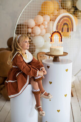 happy little girl on her birthday on the background of balloons