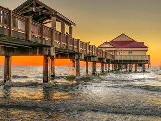 Clearwater Beach Pier at Sunset over ocean waves
