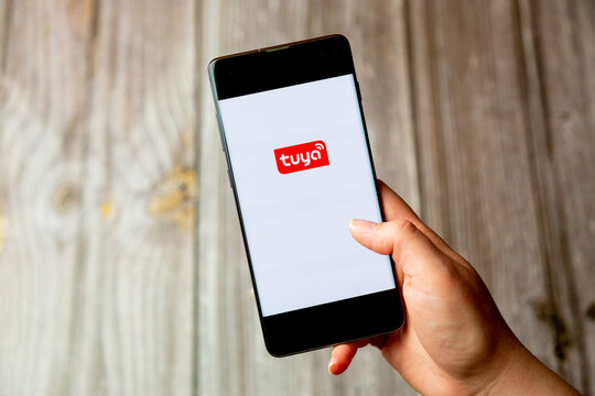 03-22-2021 Portsmouth, Hampshire, UK A mobile phone or cell phone being held in a hand with the app Tuya open on screen