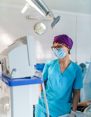 Nurse in mask on face working on quarantine. Woman in protective mask treating health in hospital.