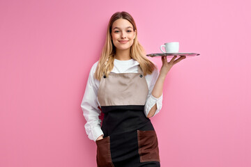 Stylish nice woman waitress in apron, offering cup of delicious tasty coffee