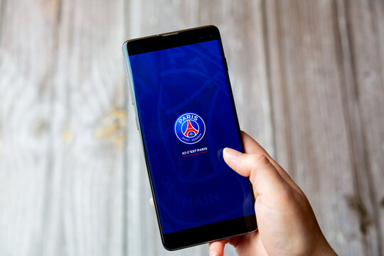 03-22-2021 Portsmouth, Hampshire, UK A mobile phone or cell phone being held in a hand with the Paris Saint Garmain or PSG app open on screen