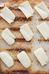 Macro shot of a grilled slice of bread, with butter pieces