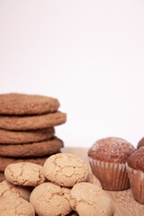 muffins, almond amaretti and oat cookies on wooden stand board. sweet bakery concept