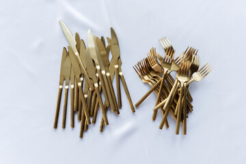 Vintage cutlery on an table covered with white tablecloth, copy space, horizontal.