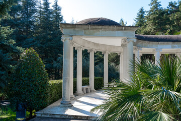 A gazebo in a classic style in a park by the sea
