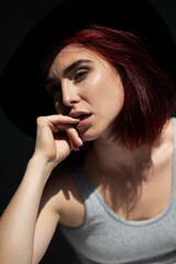 Beautiful young ginger woman wearing casual clothes posing indoor, natural light