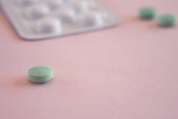 Pills on neutral background. Plastic container for medicines.