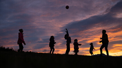 Silhouette of a family playing and having fun outside