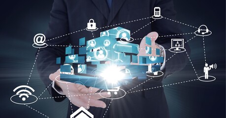 Composition of network of digital icons with glow over hands of businessman