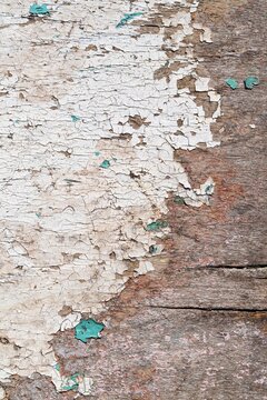 Old barnboard with paint stripped away on part of the board