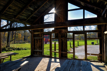 Empty damage barn house with lens flare