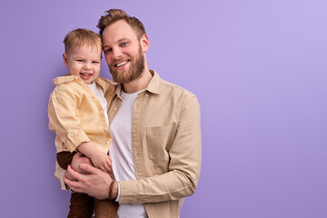 excited father and little son posing at camera smiling