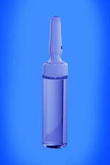 Glass ampoule with medicine on a blue background, close-up