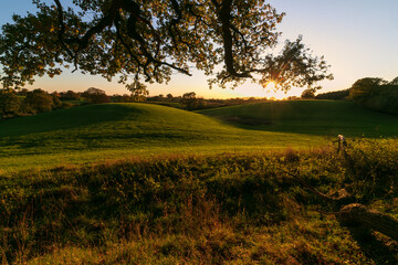 Fototapeta na wymiar Hilly farm fields at sunset in autumn