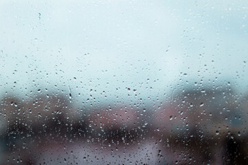 Rain drops on window glass surface. Rainy spring background