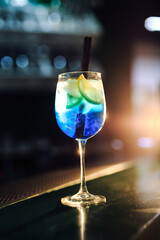 blue fresh alcohol drink with citrus and backlight