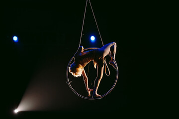 An aerial gymnast shows a performance in the circus arena. © davit85