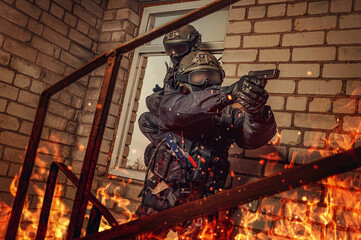 Group of special forces fighters free the hostages from a building engulfed in fire. Counter...