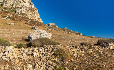 Landscape with rocky ground, rock, wall and house. Sicily - 422607489