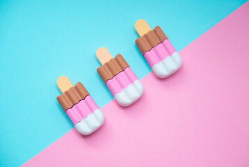 Trendy sunlight Summer with pink strawberry, vanilla and chocolate ice cream on bright light blue pink background. Minimal summer concept.