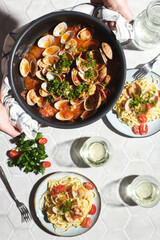 Mediterranean cuisine: pasta with seafood, with vongole. Italian lunch. Lifestal mood. Light background, top view