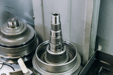Set of various engine and gearbox spare parts. Shiny gears for planetary gearbox.Metal autotechnology background. wheel engine gears, close up. Automatic transmission in section