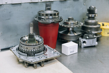Set of various engine and gearbox spare parts. Shiny gears for planetary gearbox.Metal autotechnology background. wheel engine gears, close up. Automatic transmission in section