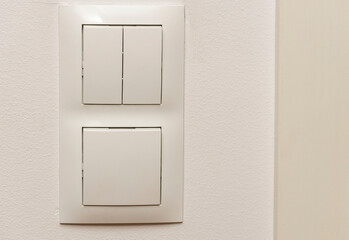 View of white light switch pair on wall . Building construction elements concept. Interior. Design.