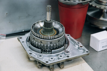 Set of various engine and gearbox spare parts. Shiny gears for planetary gearbox.Metal autotechnology background. wheel engine gears, close up. Automatic transmission in section