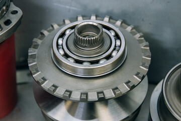 Set of various engine and gearbox spare parts. Shiny gears for planetary gearbox.Metal autotechnology background. wheel engine gears, close up. Automatic transmission in section