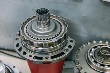 Set of various engine and gearbox spare parts. Shiny gears for planetary gearbox.Metal autotechnology background. wheel engine gears, close up. Automatic transmission in section
