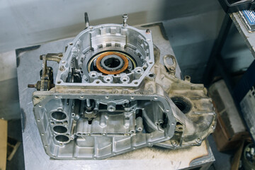Set of various engine and gearbox spare parts. Shiny gears for planetary gearbox.Metal autotechnology background. wheel engine gears, close up. Automatic transmission in section