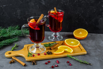 mulled wine in a transparent glass. orange, pomegranate, cinnamon, cardamom, spices. fruit compote....