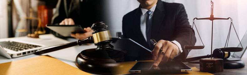 Business and lawyers discussing contract papers with brass scale on desk in office. Law, legal services, advice, justice and law concept picture with film grain effect