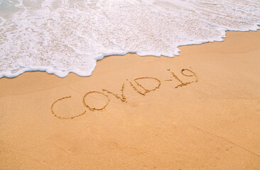 Closeup image of sea waves washing the word 