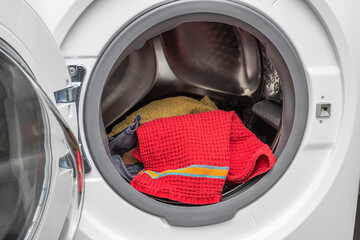 Close up view of washed laundry in a laundry  machine. Home routine concept. Sweden.