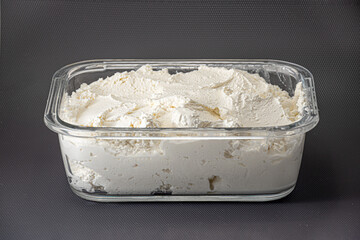Fresh cottage cheese in glass container - curd isolated